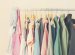 Pastel Color Female Clothes in a Row on Open Hanger. Toned image